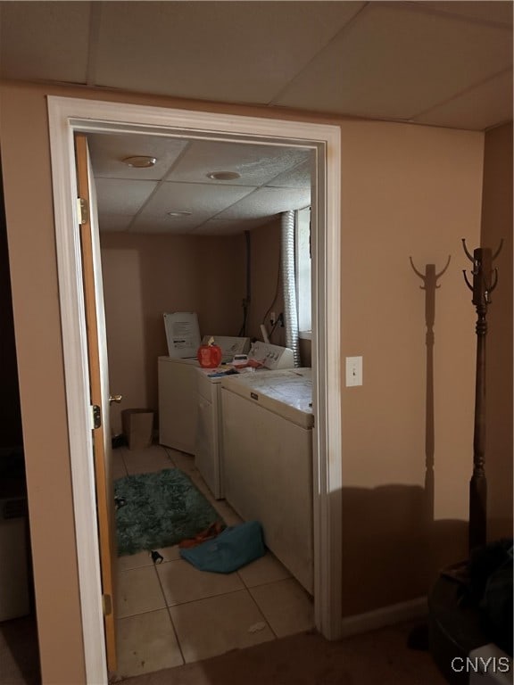 washroom featuring light tile patterned flooring and washing machine and clothes dryer