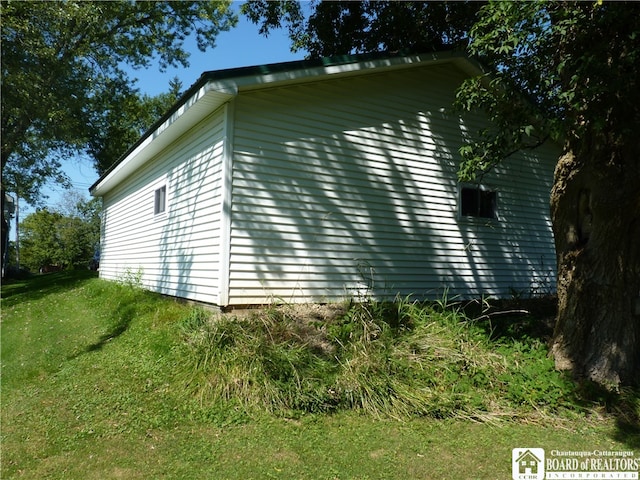 view of home's exterior with a yard