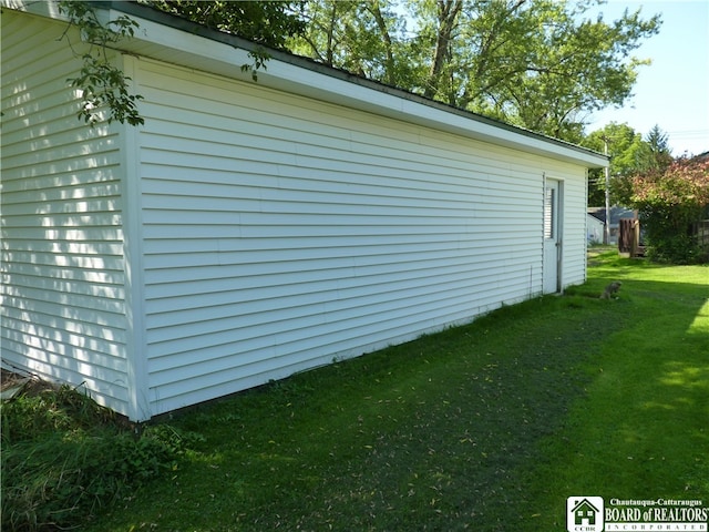 view of side of property with a yard