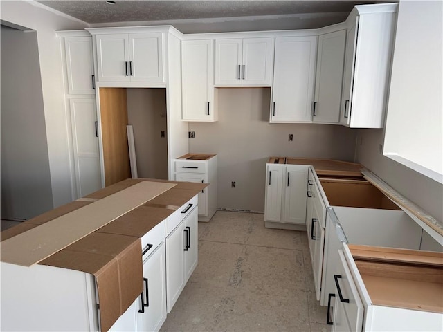 kitchen with a center island and white cabinets