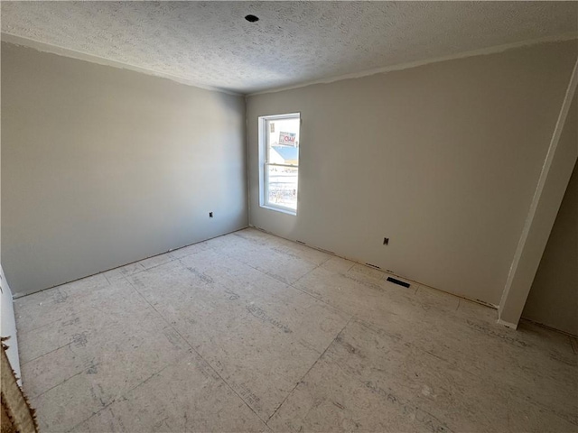 spare room featuring a textured ceiling