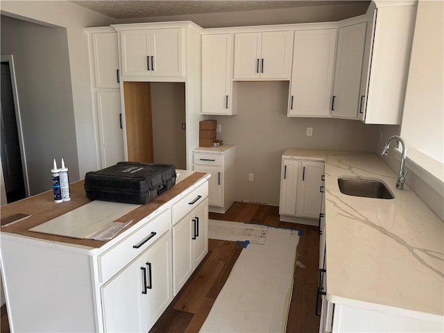 36 Kaye Park Ter, Gates, NY 14624 - kitchen with a center island, dark wood-style floors, white cabinets, and light stone counters