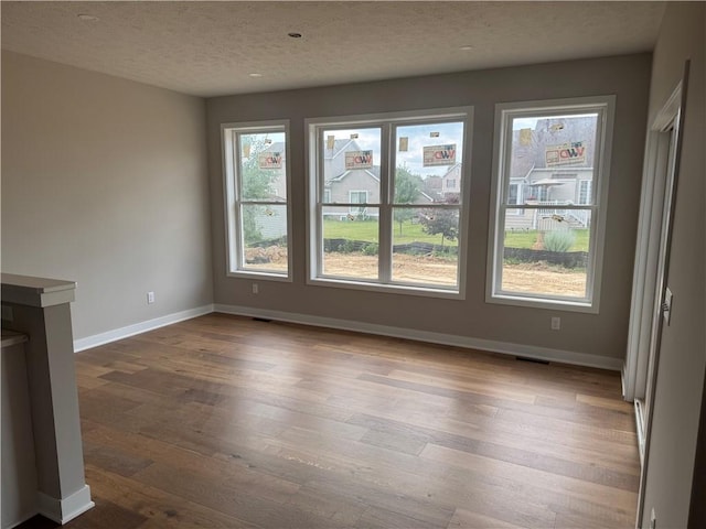36 Kaye Park Ter, Gates, NY 14624 - unfurnished room featuring dark wood-type flooring and a textured ceiling