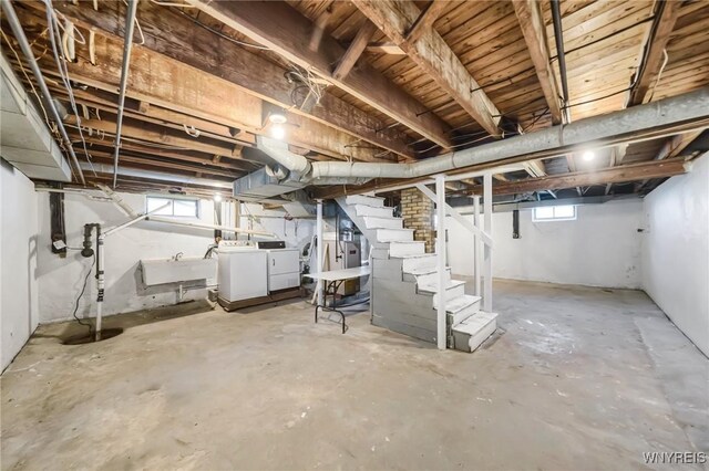 basement featuring washer and dryer and sink