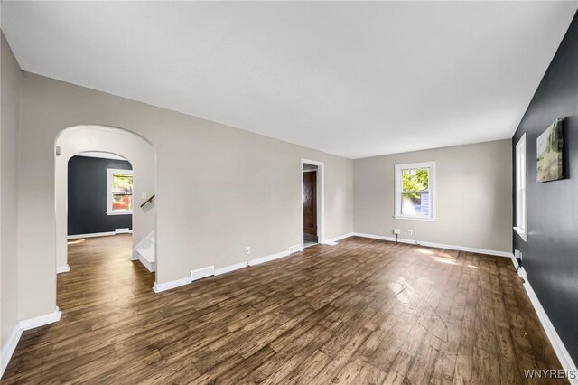 unfurnished room with dark hardwood / wood-style flooring