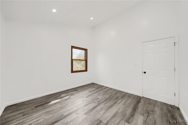 empty room with hardwood / wood-style floors