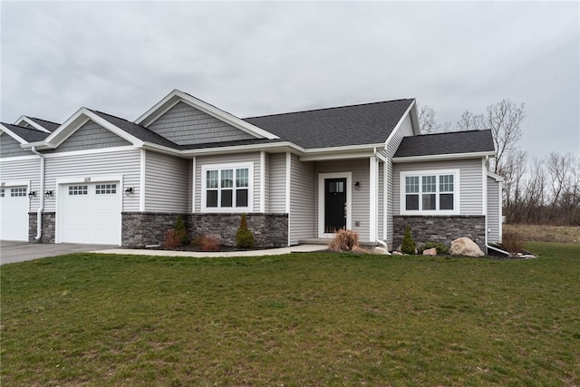 craftsman house with a garage and a front yard