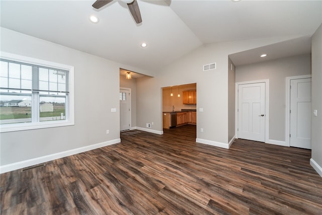 unfurnished living room with dark wood-type flooring, ceiling fan, and vaulted ceiling