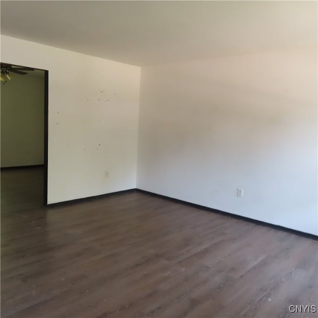 empty room with dark hardwood / wood-style floors