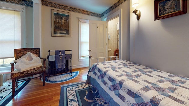 bedroom with hardwood / wood-style floors