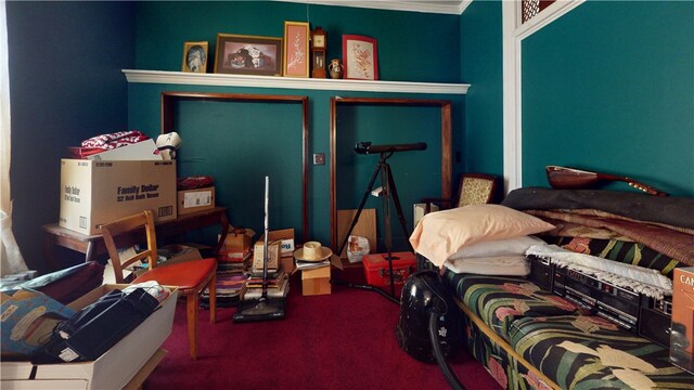 bedroom with ornamental molding and carpet floors