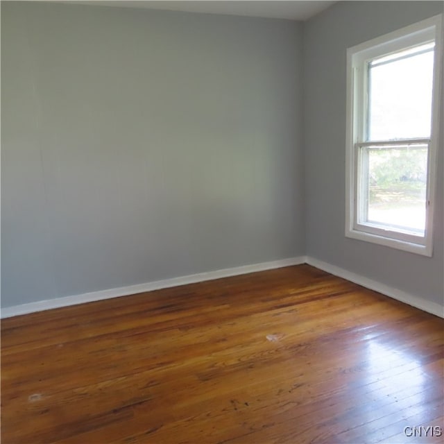 empty room with dark hardwood / wood-style flooring