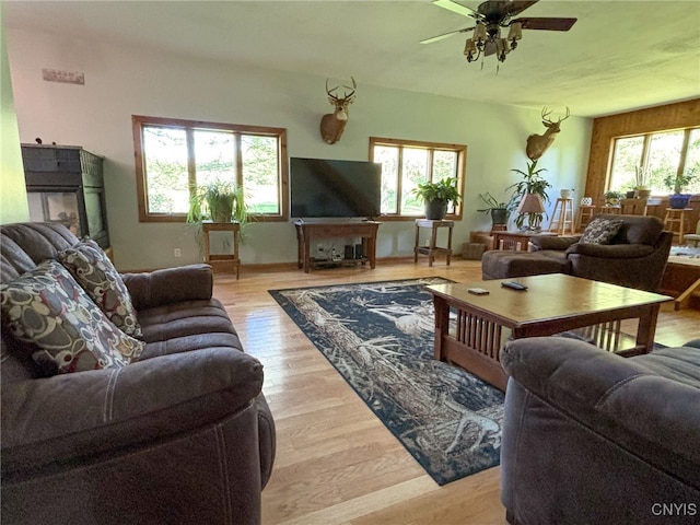 living room with light wood-type flooring and ceiling fan