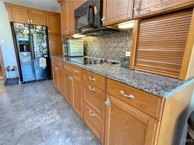 kitchen with black appliances, tasteful backsplash, and stone countertops