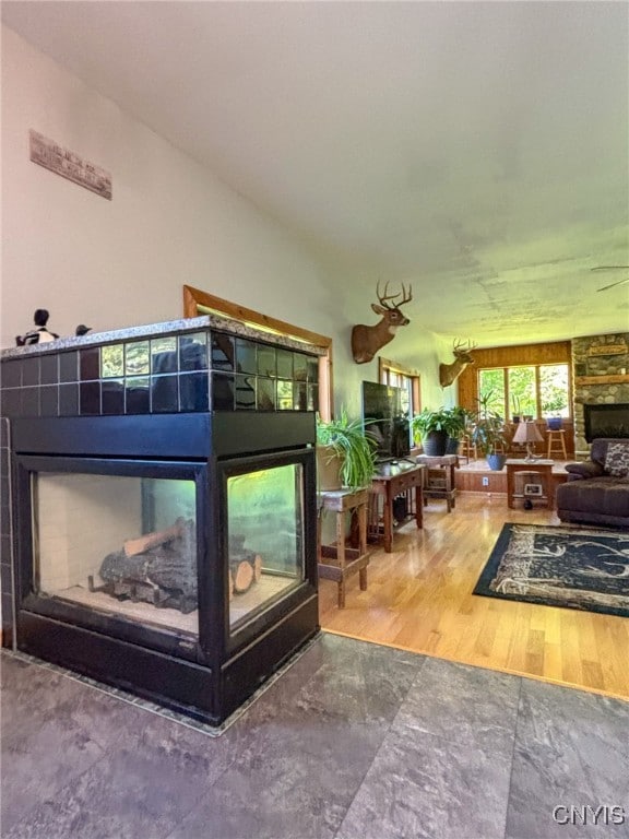 bedroom featuring wood-type flooring and a fireplace