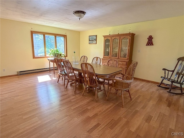 dining area with hardwood / wood-style flooring and a baseboard radiator