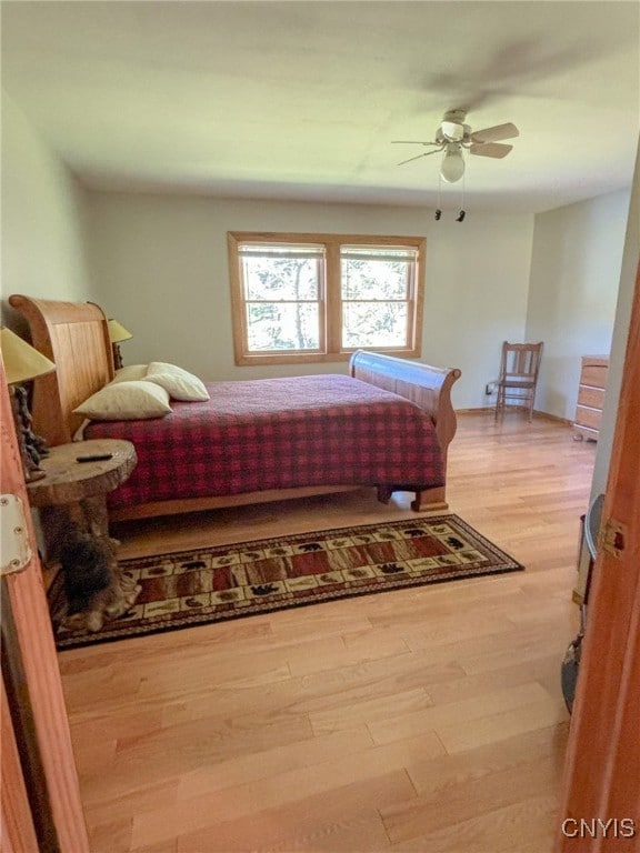 bedroom featuring hardwood / wood-style flooring and ceiling fan