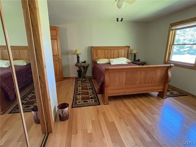 bedroom featuring light wood-type flooring, a closet, and ceiling fan