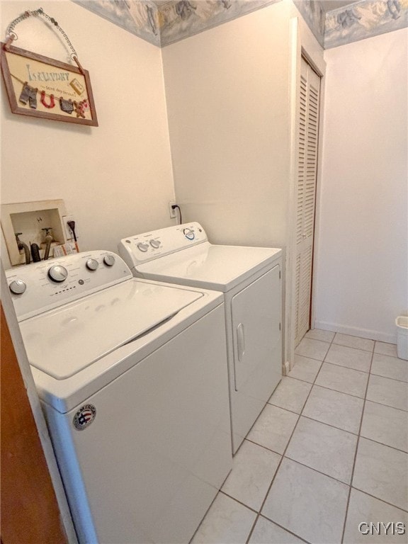 washroom with washer and dryer and light tile patterned flooring