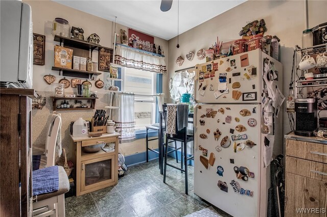 interior space featuring white refrigerator and ceiling fan