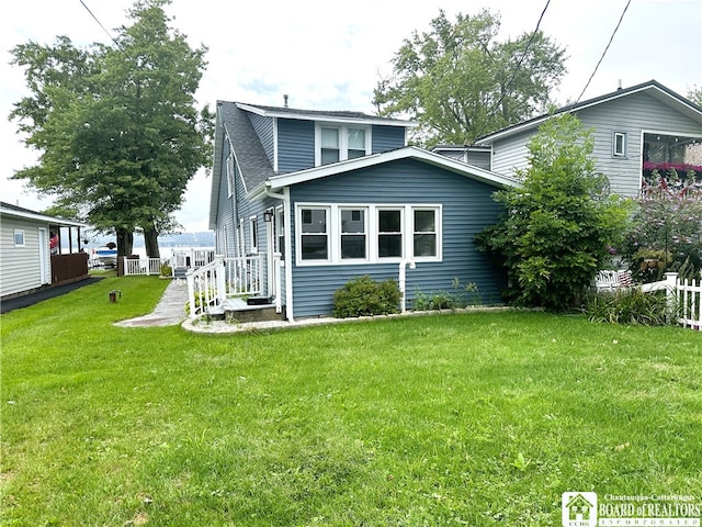 rear view of property featuring a yard