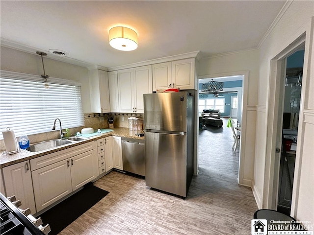 kitchen featuring light hardwood / wood-style flooring, stainless steel appliances, white cabinetry, and sink