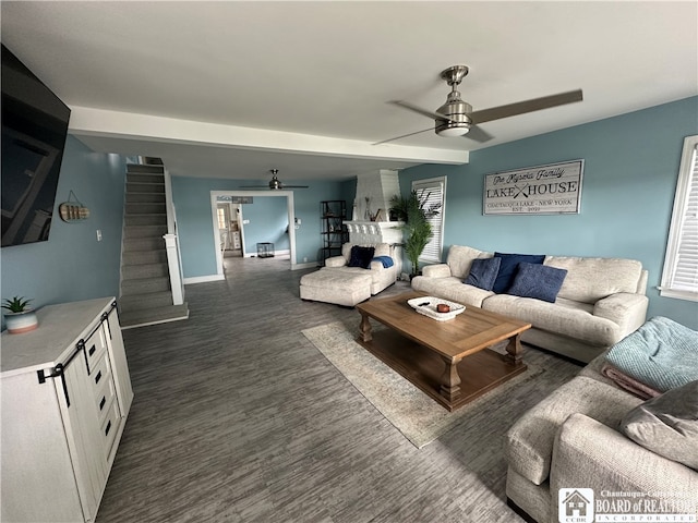 living room with dark hardwood / wood-style flooring and ceiling fan