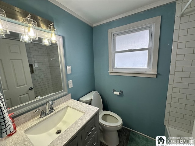 full bathroom with toilet, tiled shower / bath combo, crown molding, and vanity