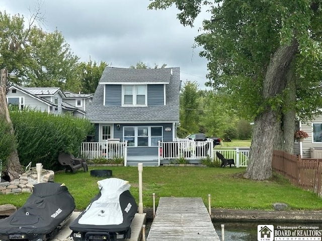 rear view of house with a wooden deck and a yard