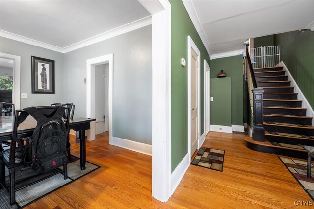 interior space with ornamental molding and light hardwood / wood-style flooring