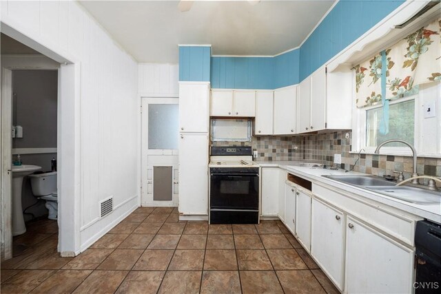 kitchen featuring dishwasher, white cabinetry, sink, and electric stove