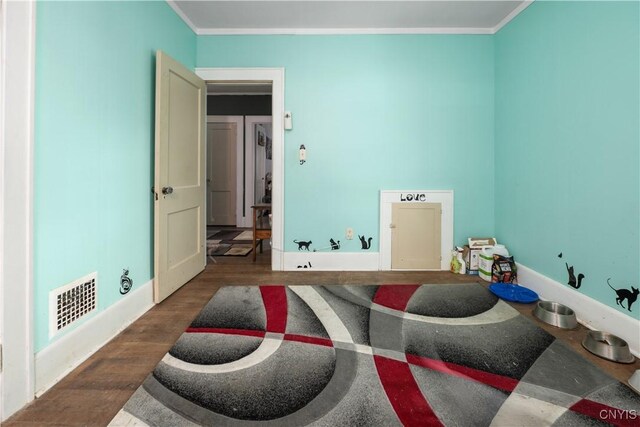 interior space featuring crown molding and hardwood / wood-style flooring