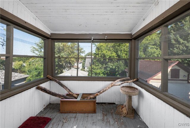 sunroom / solarium featuring wood ceiling and a healthy amount of sunlight