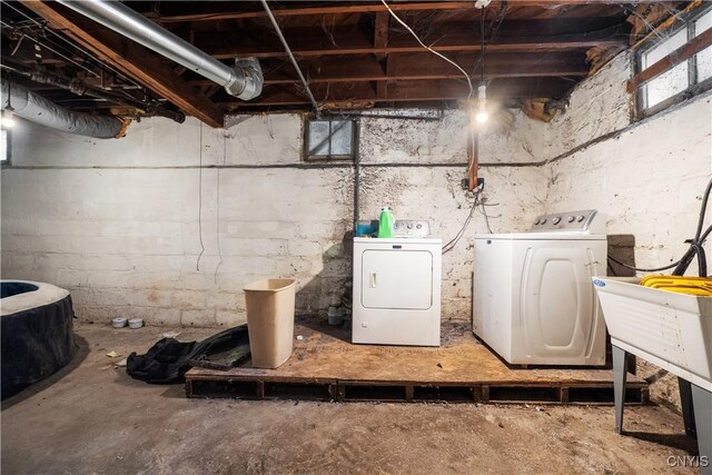 basement with separate washer and dryer and sink