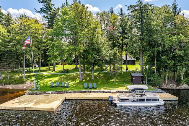 dock area featuring a water view and a lawn