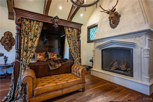 living room featuring high vaulted ceiling, hardwood / wood-style flooring, and beamed ceiling