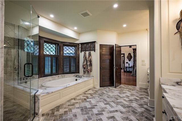 bathroom featuring vanity and separate shower and tub