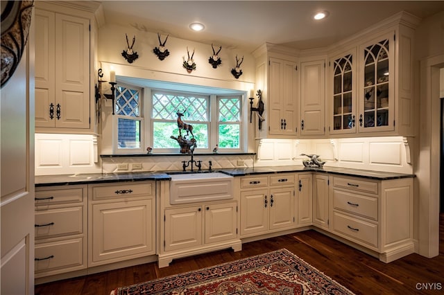 kitchen with dark hardwood / wood-style floors, sink, and white cabinets