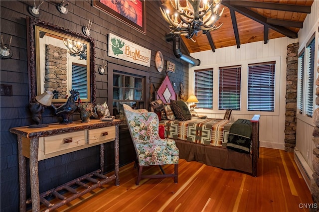 interior space featuring hardwood / wood-style flooring, an inviting chandelier, lofted ceiling with beams, and wooden ceiling