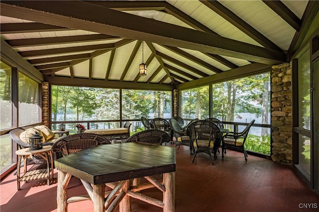 sunroom / solarium with vaulted ceiling with beams