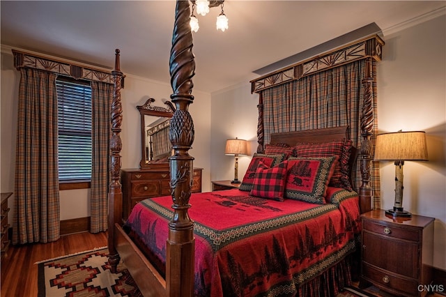 bedroom featuring hardwood / wood-style floors and crown molding