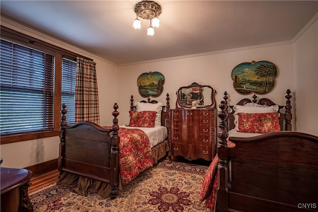 bedroom with crown molding and hardwood / wood-style flooring