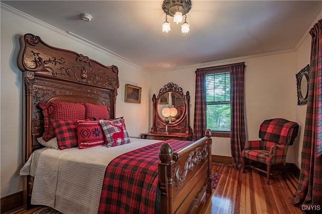 bedroom featuring crown molding and dark wood-type flooring