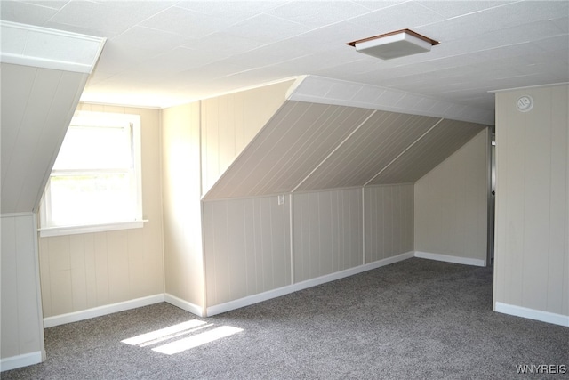 bonus room with lofted ceiling and carpet