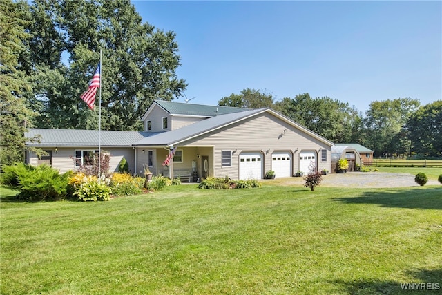 view of front of home with a front yard and a garage