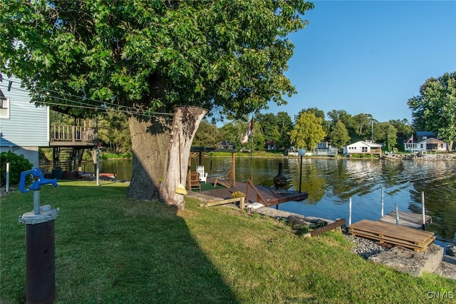 dock area featuring a lawn and a water view