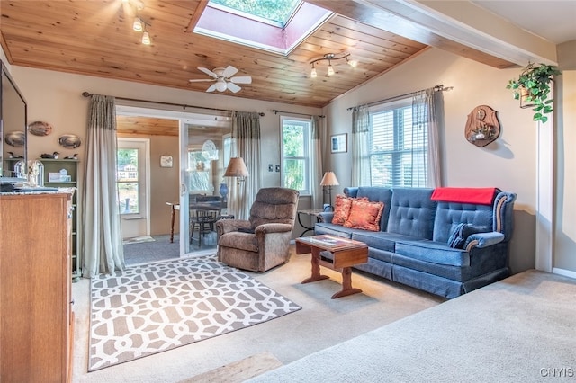 living room featuring ceiling fan, carpet flooring, wooden ceiling, and a wealth of natural light