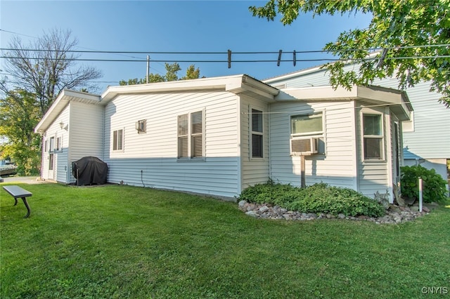 view of side of home featuring a yard