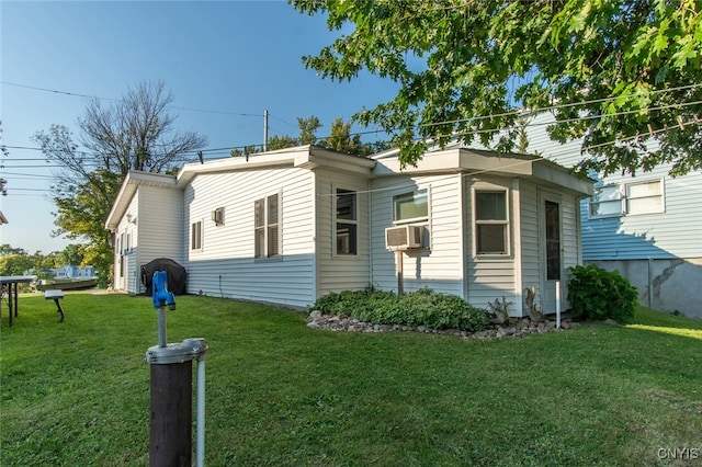 view of side of home with a lawn