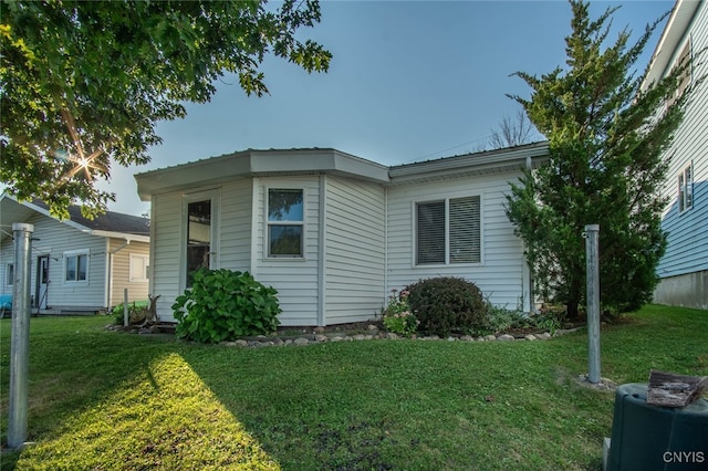 view of side of property with a yard